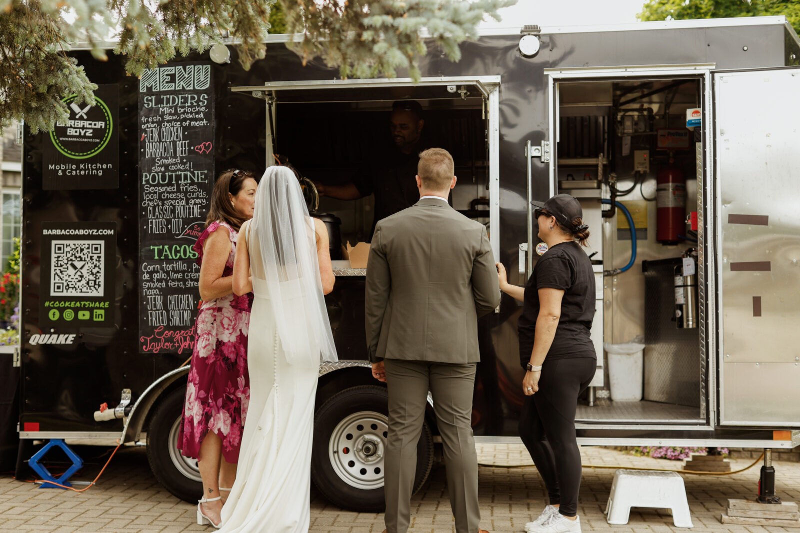 Bride and Groom in front of food truck.