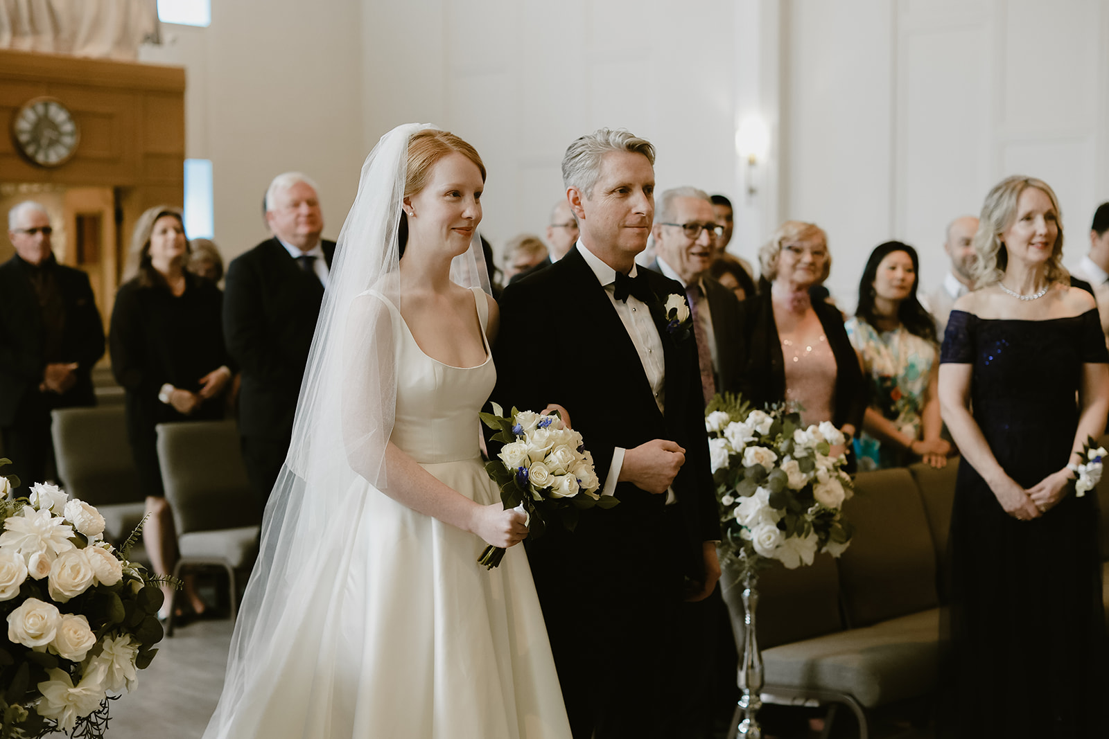 Bride walks down the aisle with father. 