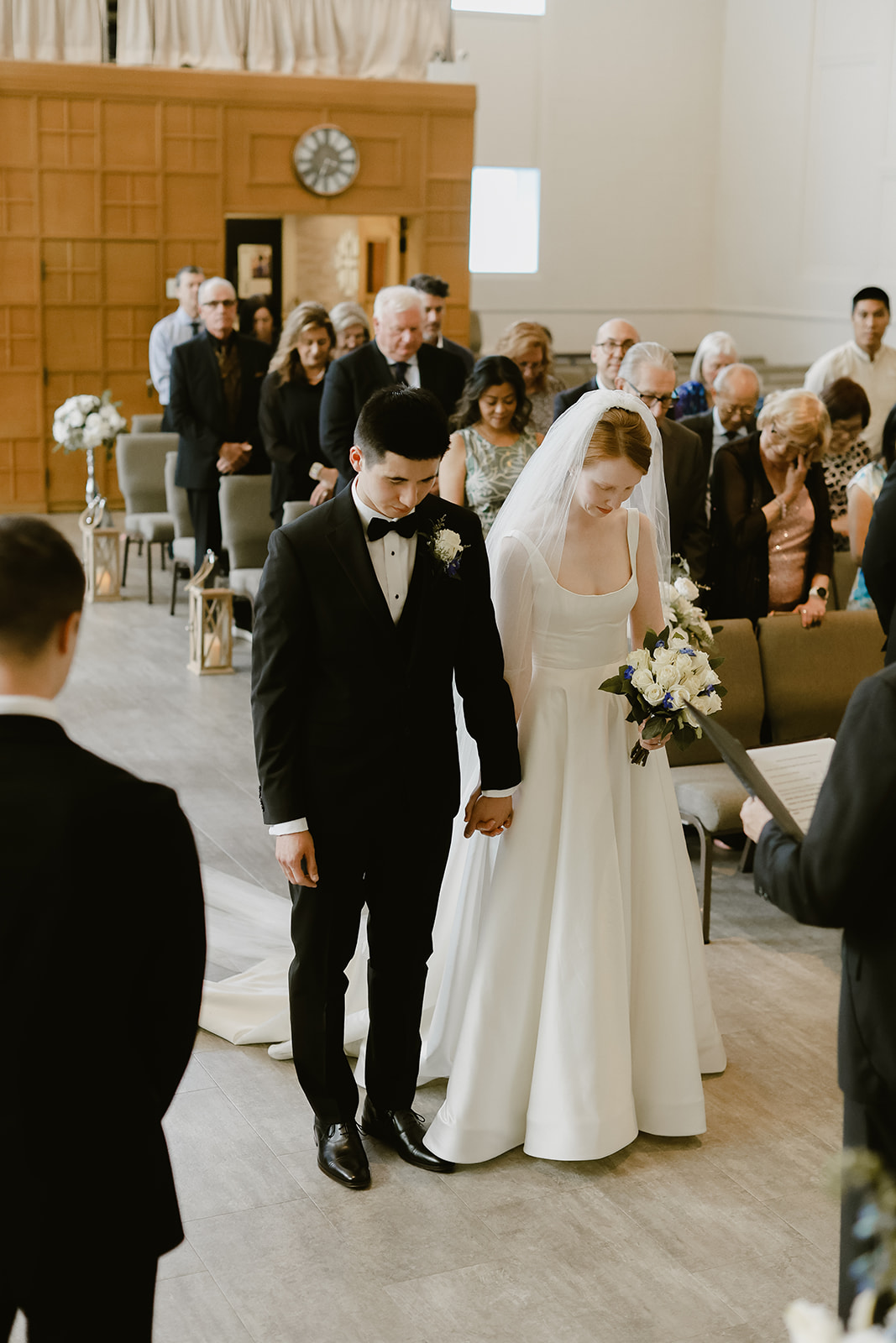 Bride and Groom bow there heads for prayer. 