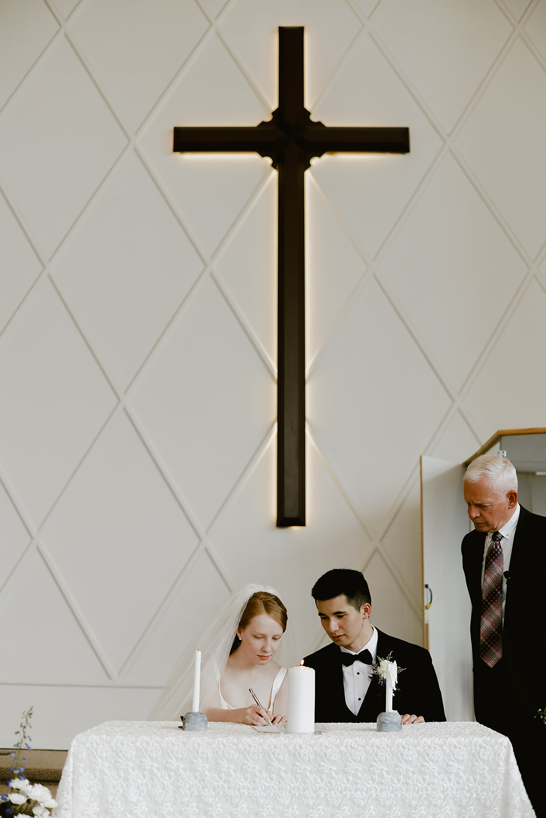 Bride and Groom sign papers