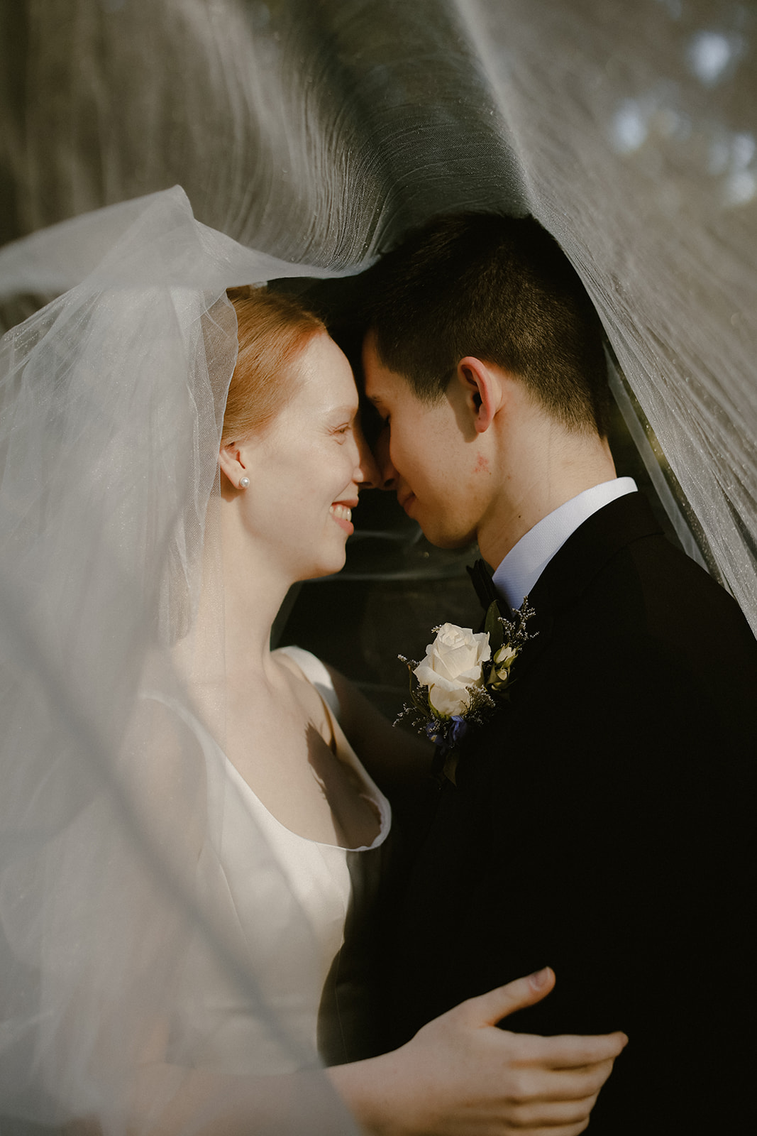 Bride and Groom under veil.