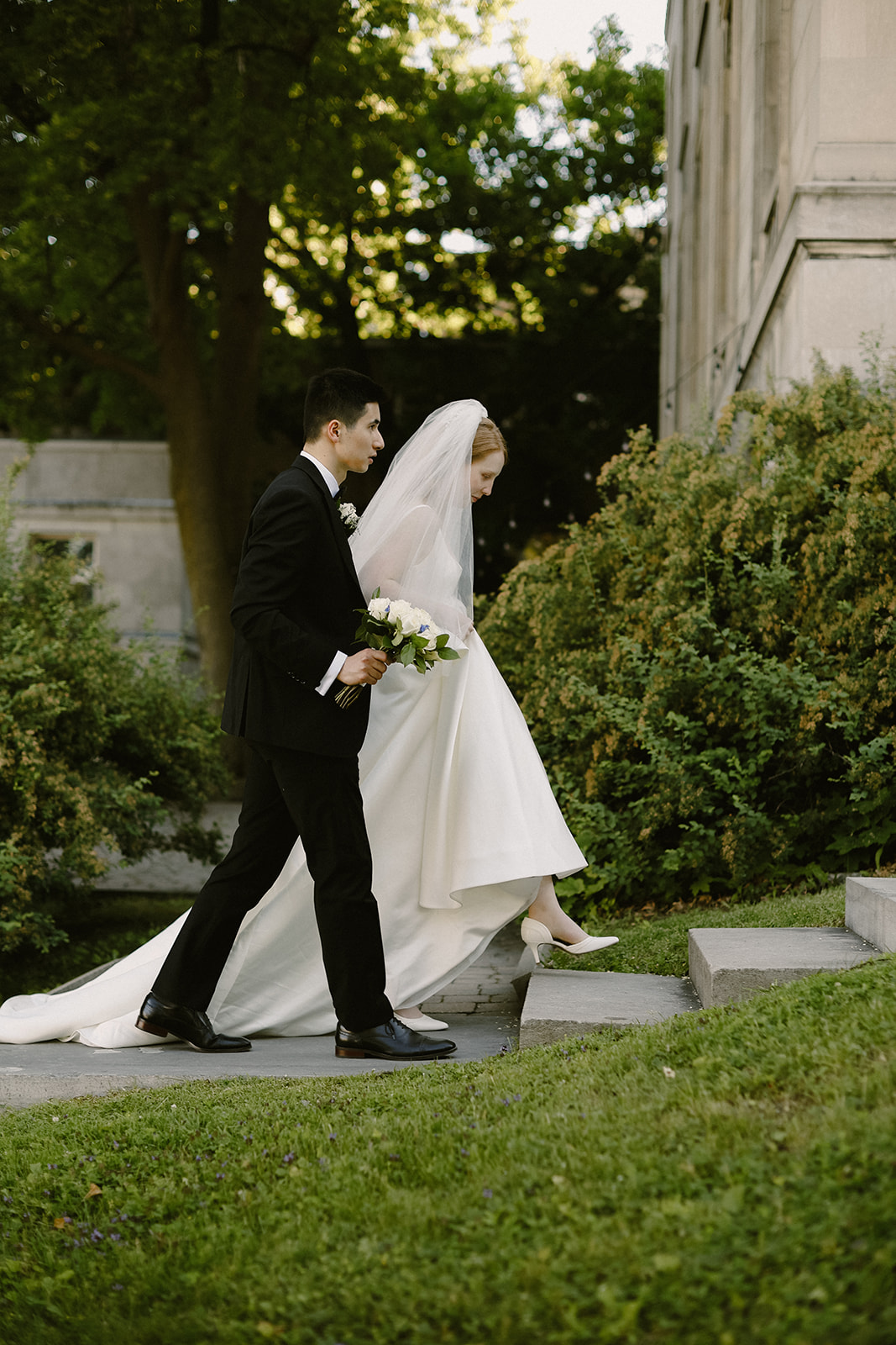 Bride and Groom walk up steps