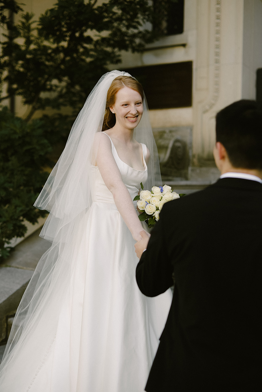 bride smiles at groom