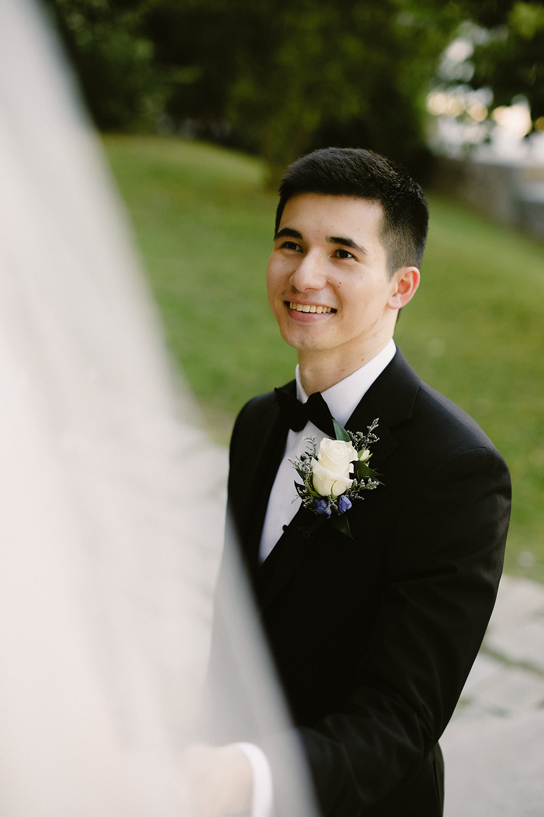 Groom smiles at bride