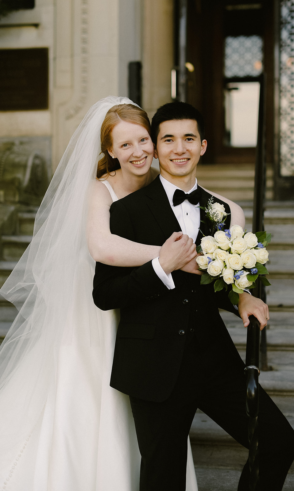 Bride and groom smile at camera