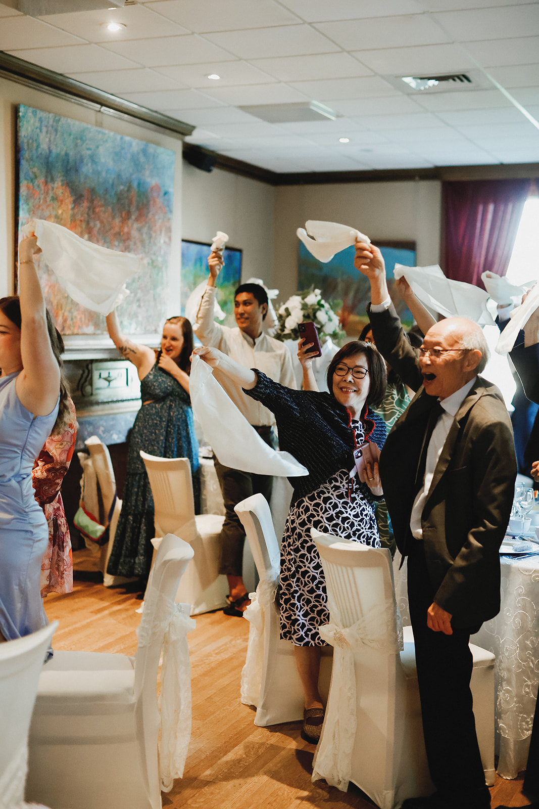 Guest wave napkins as Bride and Groom walk into reception