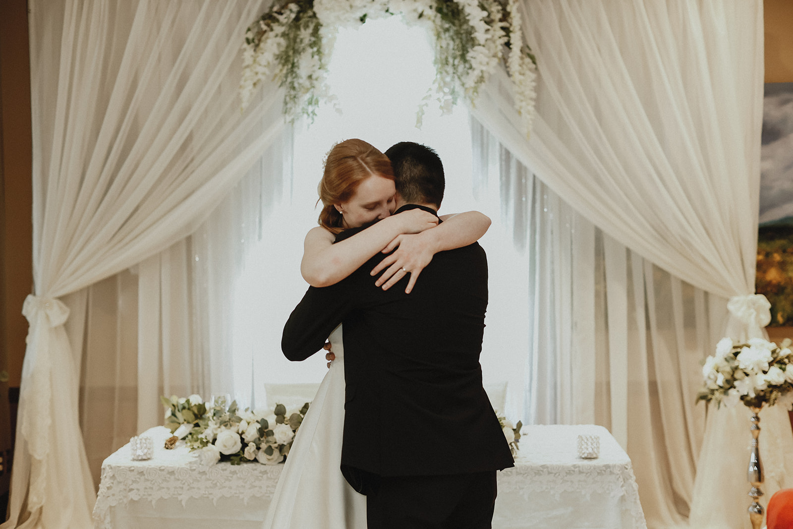 Bride and groom hug