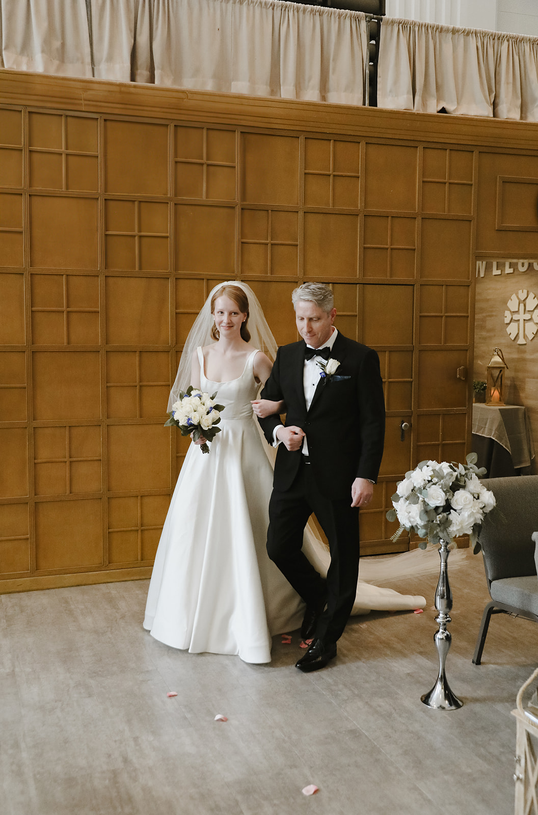 Bride walks down the aisle with father. 