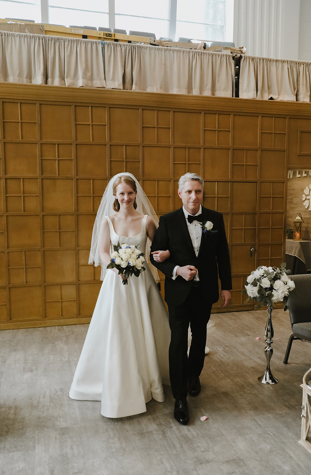 Bride walks down the aisle with father. 