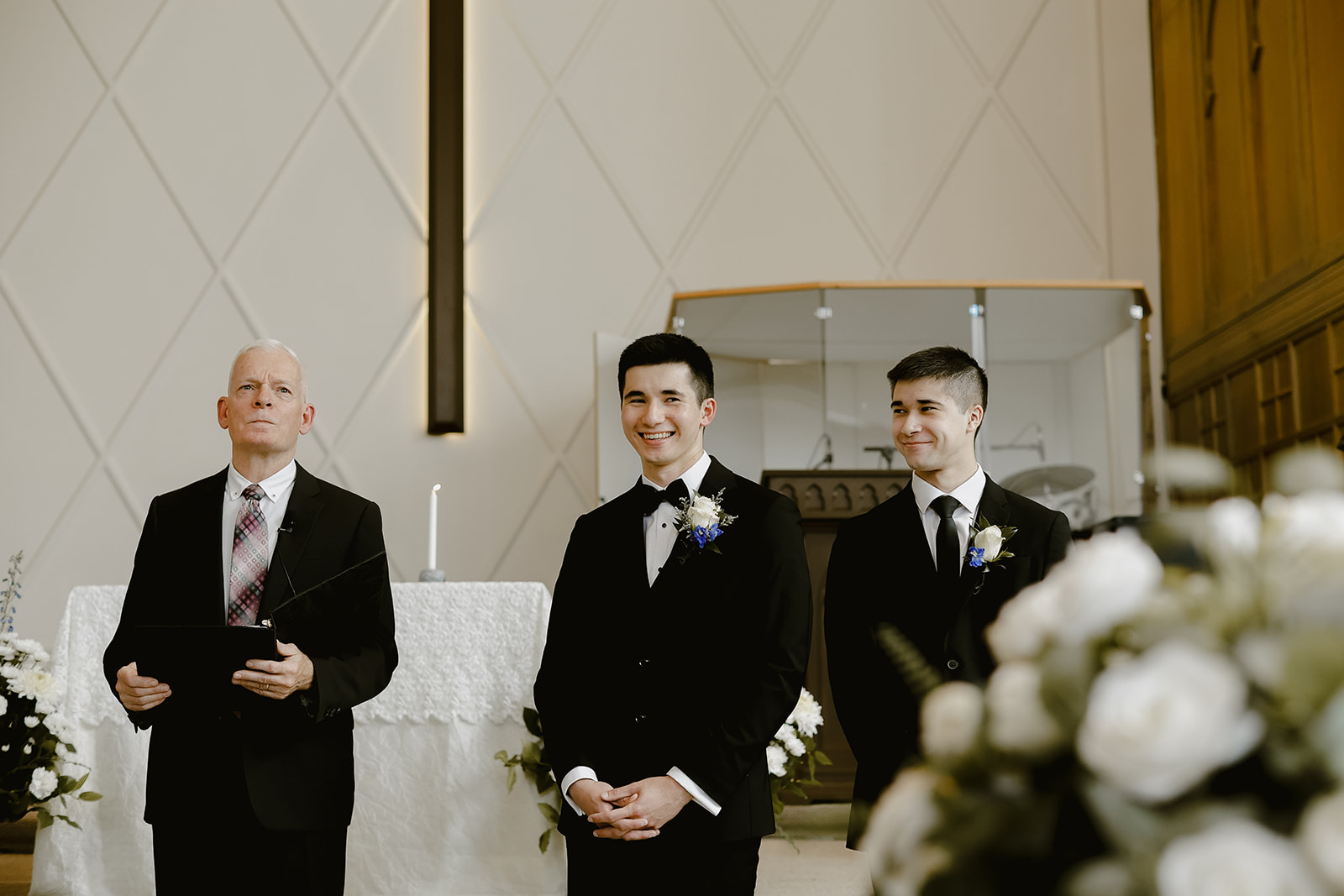 Groom stands at altar with brother.