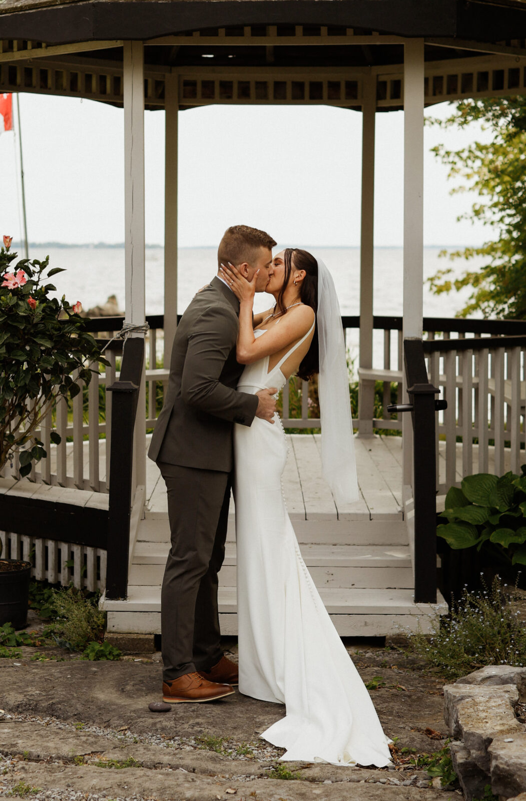 Bride and Groom Kiss at alter - Wedding Photography - Kingston ON