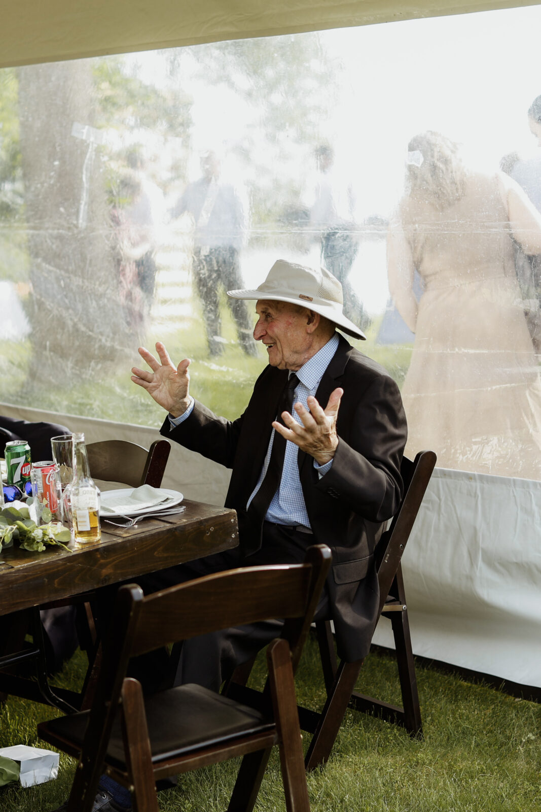 Older man in mid conversation, has hands in the air.