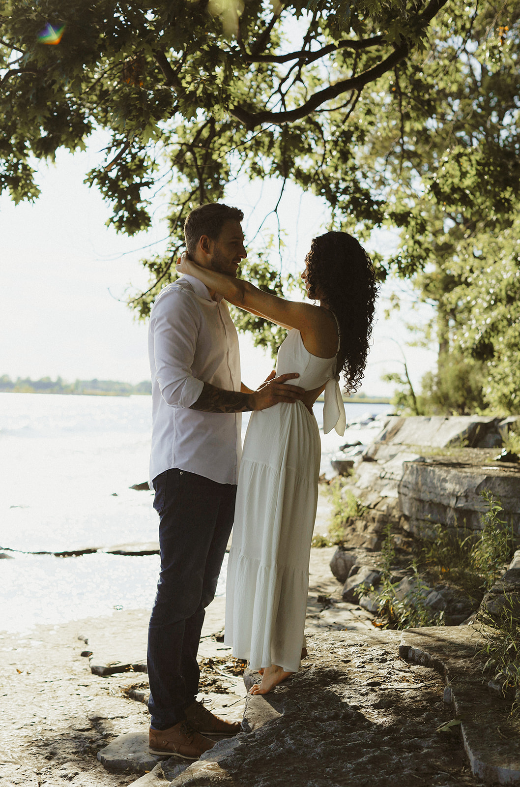 couple under trees on Lake Ontario shoreline