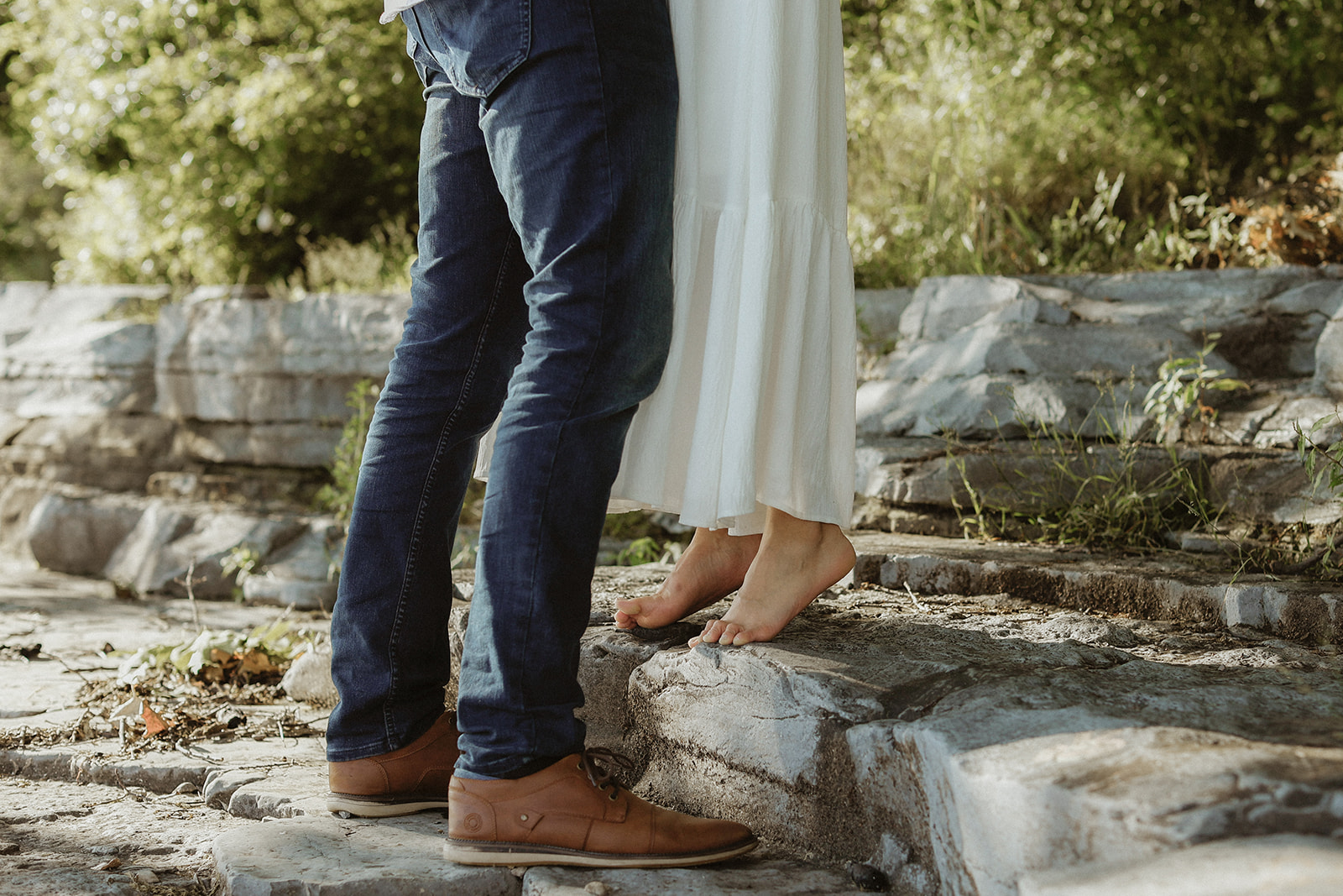 woman in bare feet along lake Ontario shoreline. Engagement phtography