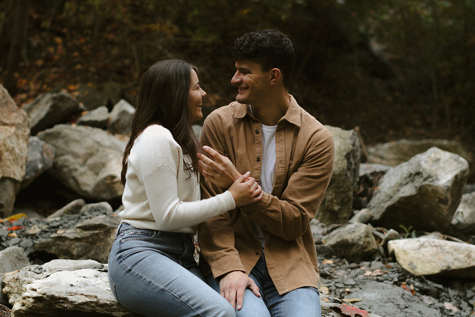 Couple sitting in scenic landscape - Engagement Photoshoot