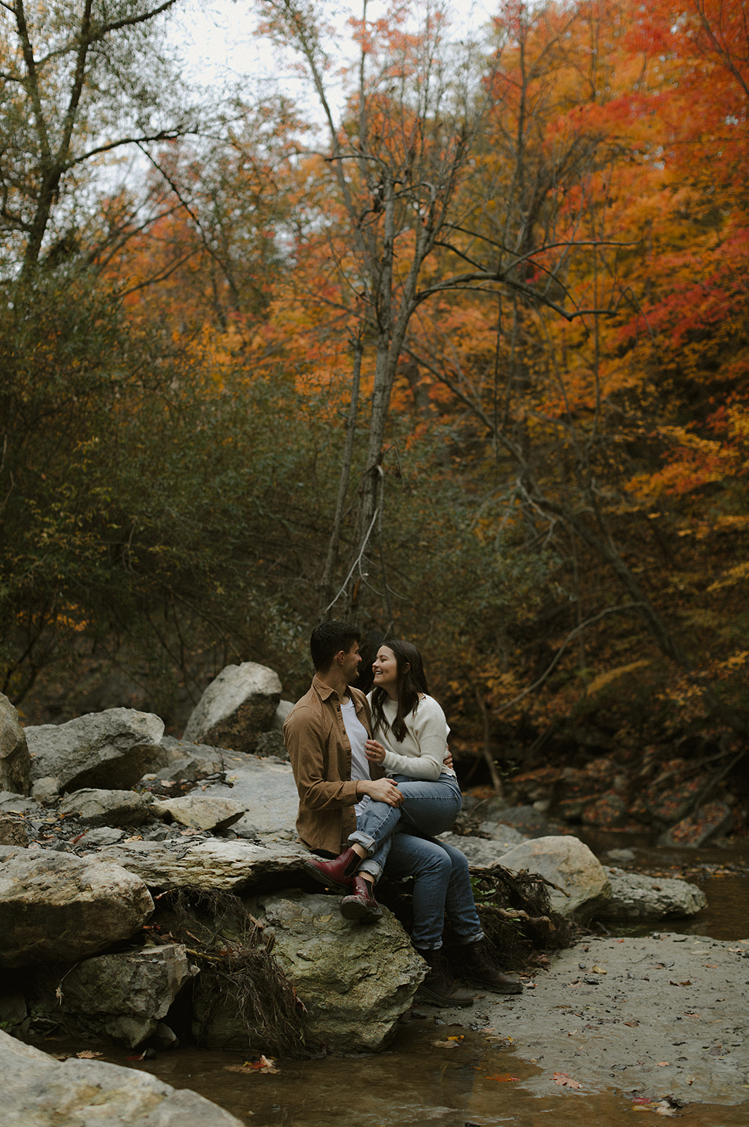 Couple sitting in scenic landscape - Engagement Photoshoot