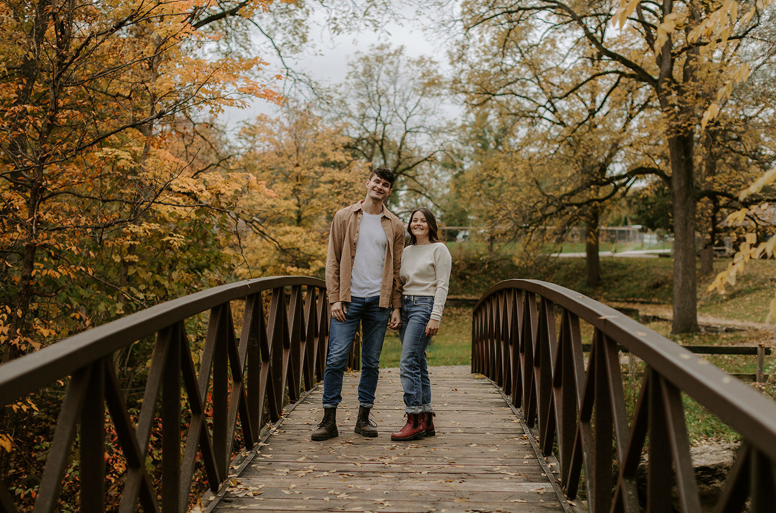 Engagement Photoshoot in Kingston, ON. Couple standing on bridge.