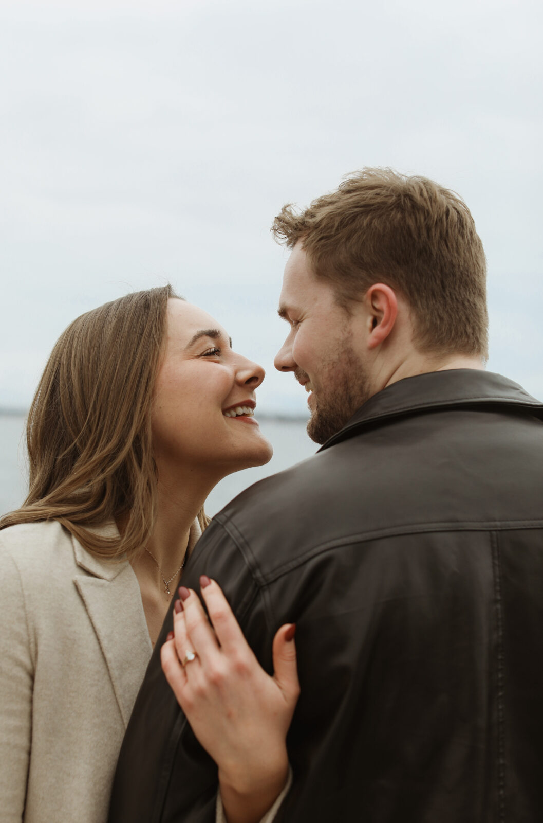 Couple next to lake Ontario- Kingston Ontario Engagement photo shoot 