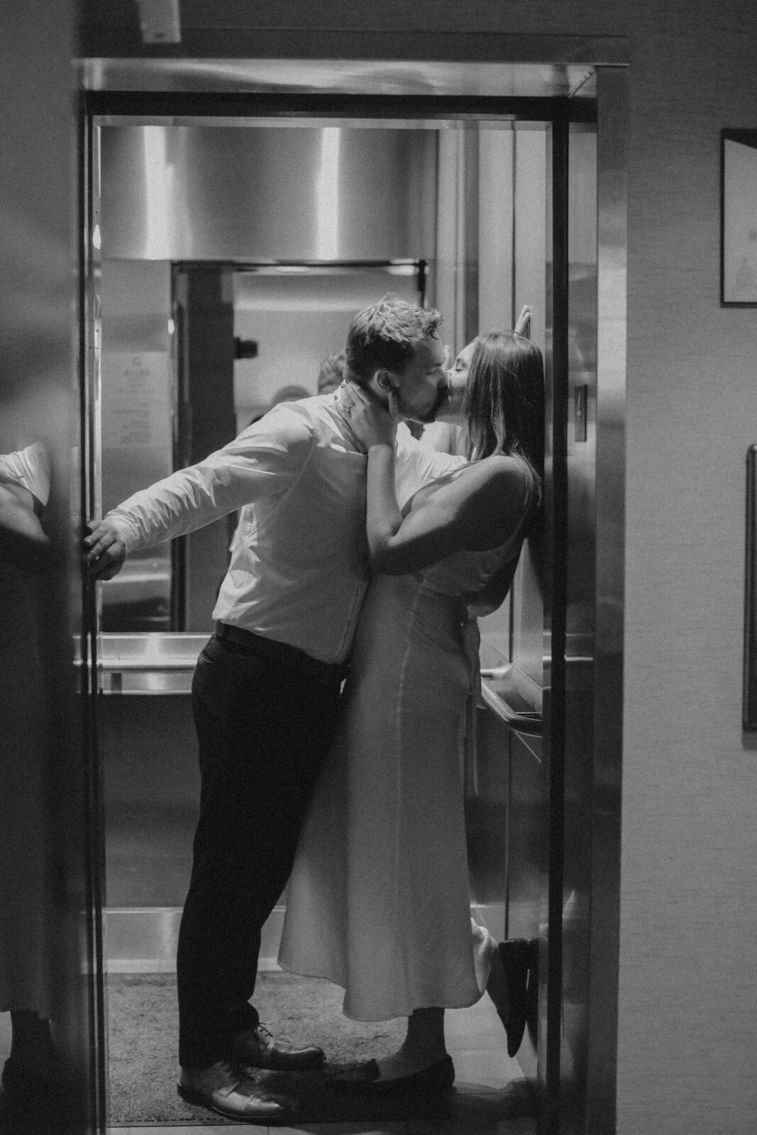 couple kisses in elevator