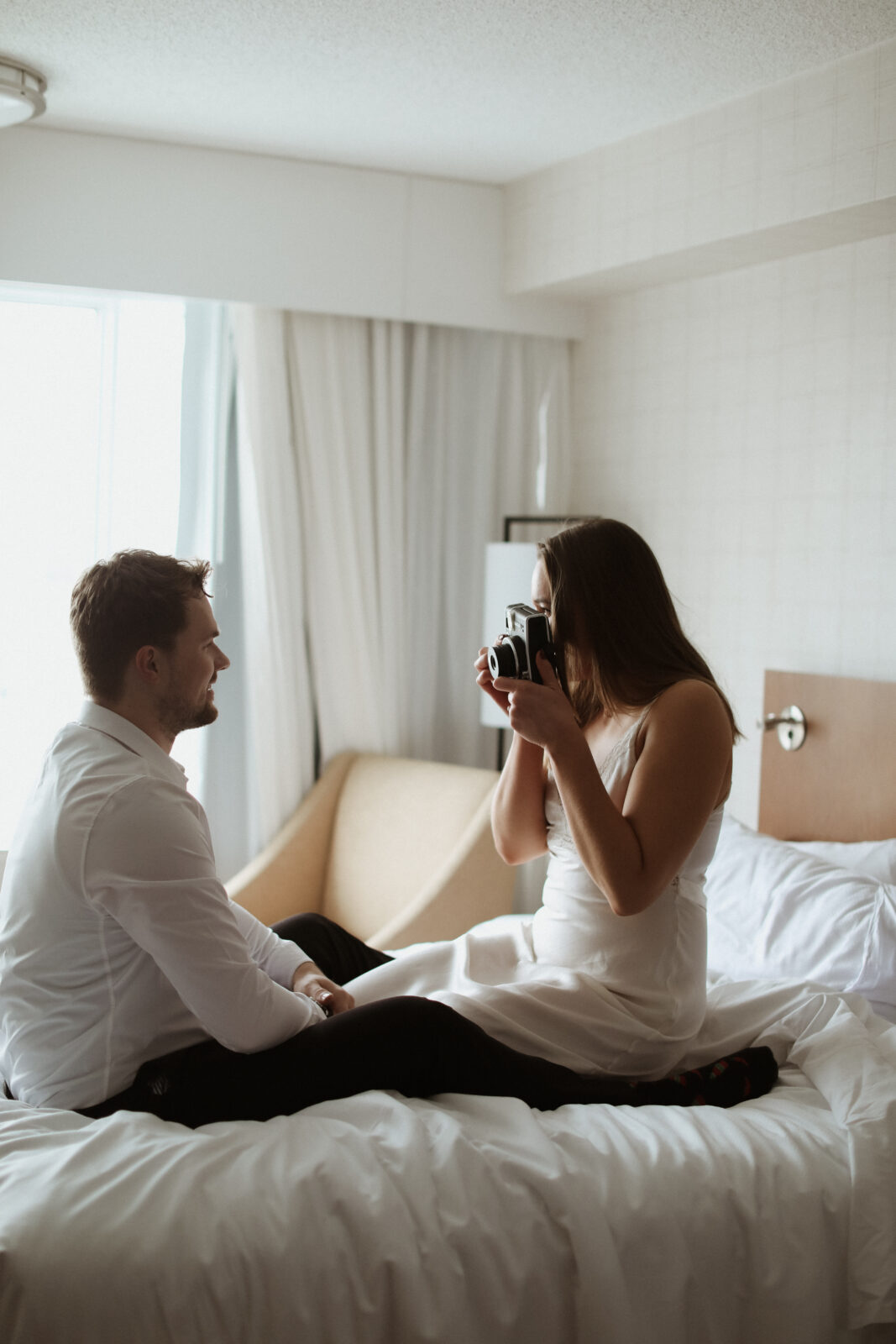 couple takes photo with polaroid camera