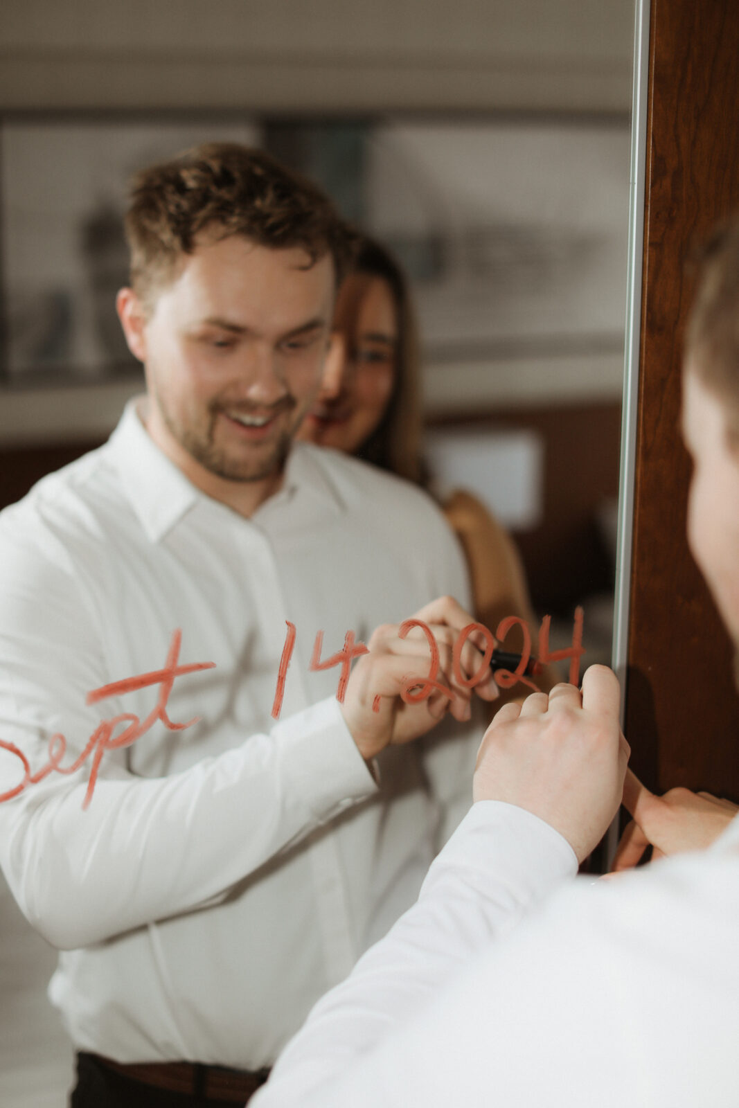 man write wedding date on mirror with lipstick 