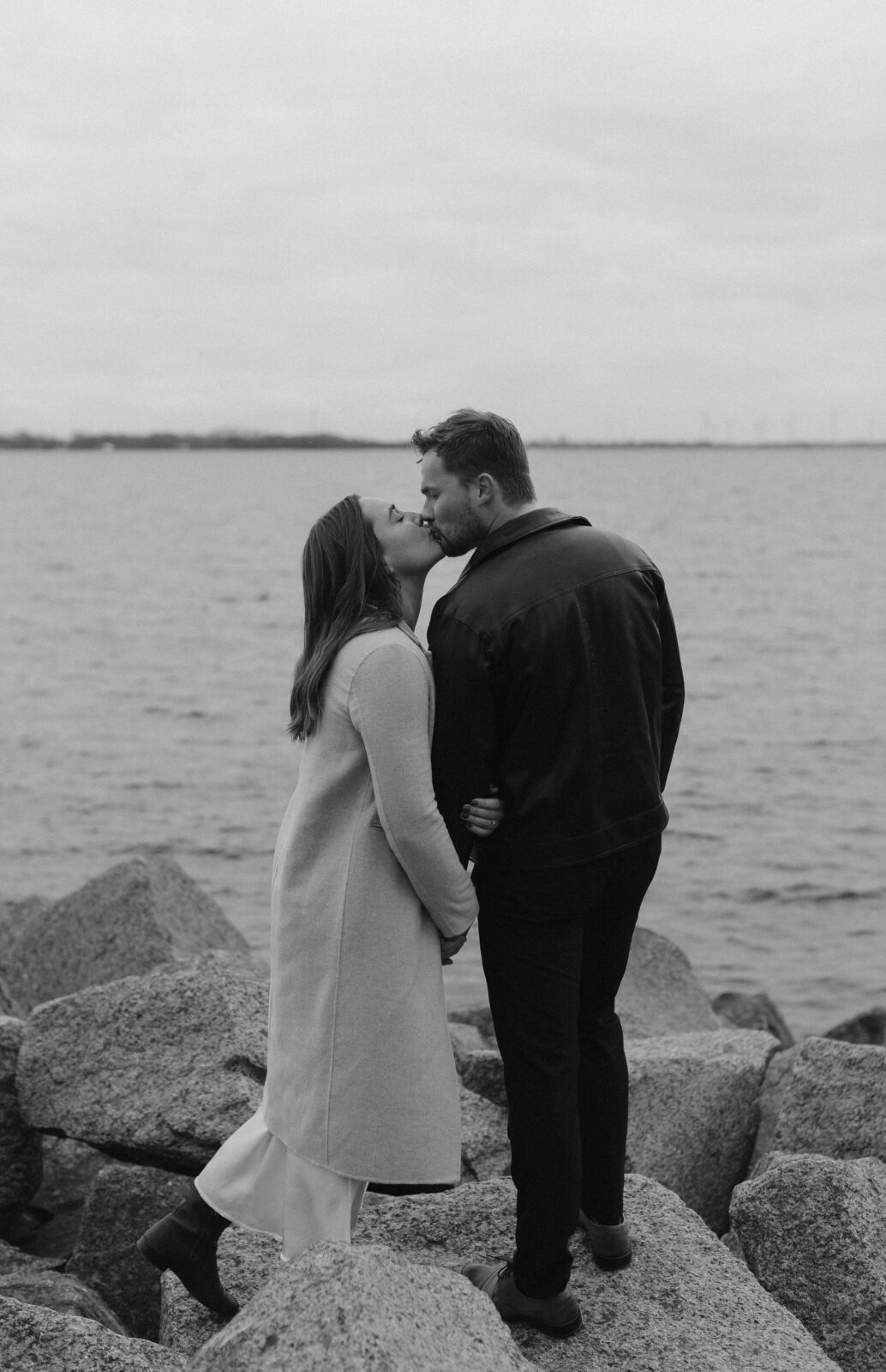 Couple next to lake Ontario- Kingston Ontario Engagement photo shoot 