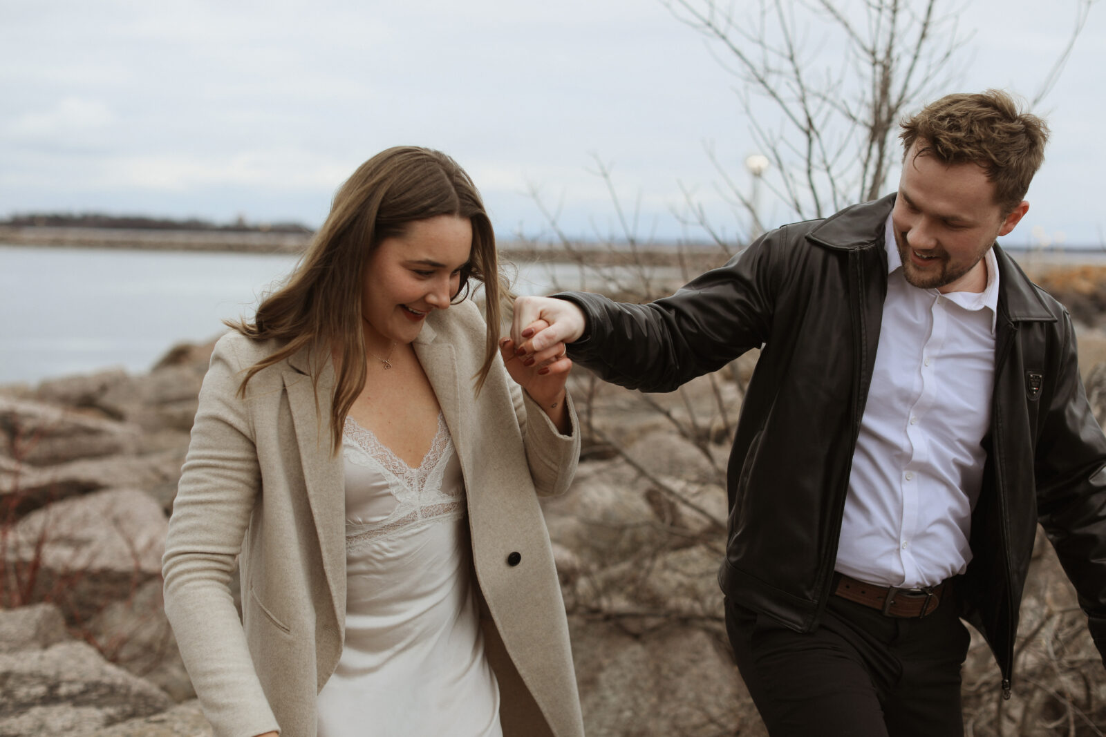 Couple next to lake Ontario- Kingston Ontario Engagement photo shoot 