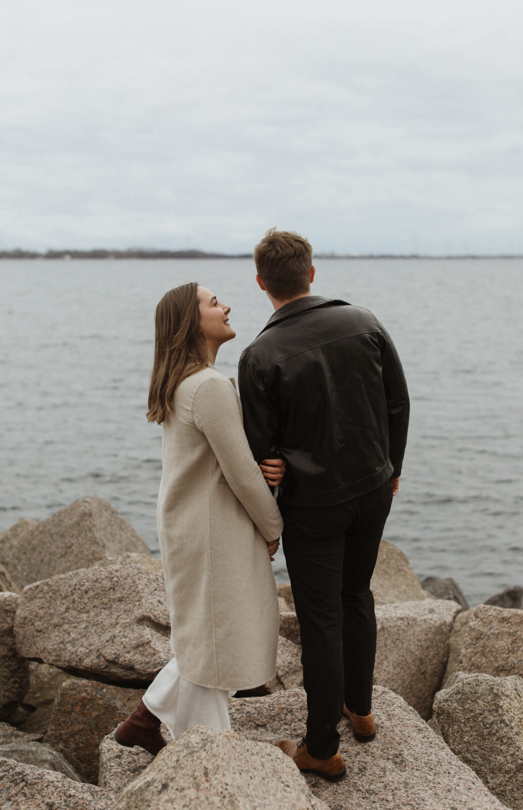 Couple next to lake Ontario- Kingston Ontario Engagement photo shoot 