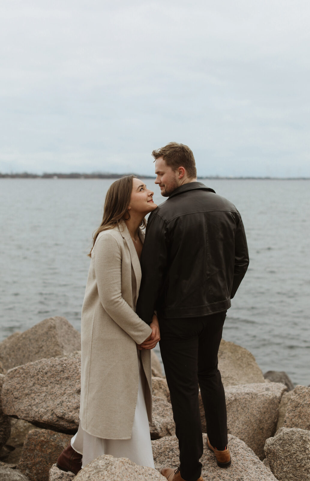 Couple next to lake Ontario- Kingston Ontario Engagement photo shoot 