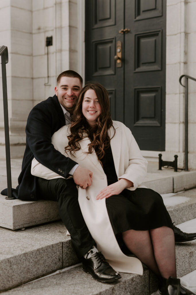couple sits on limestone stairs