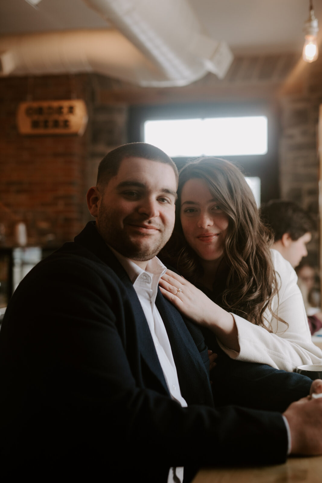 couple sits in coffee shop