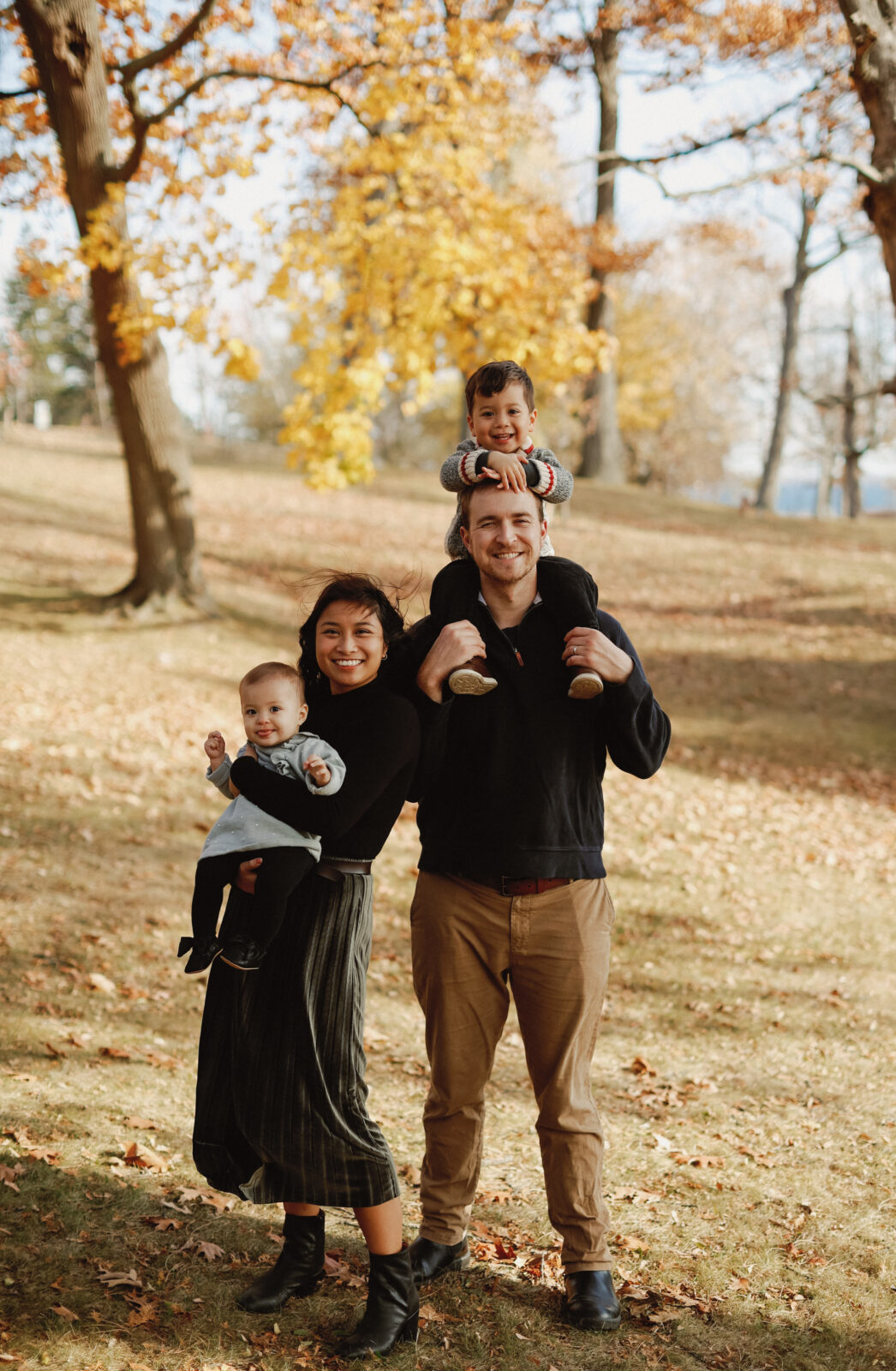 Family smiles at camera. Kingston ON