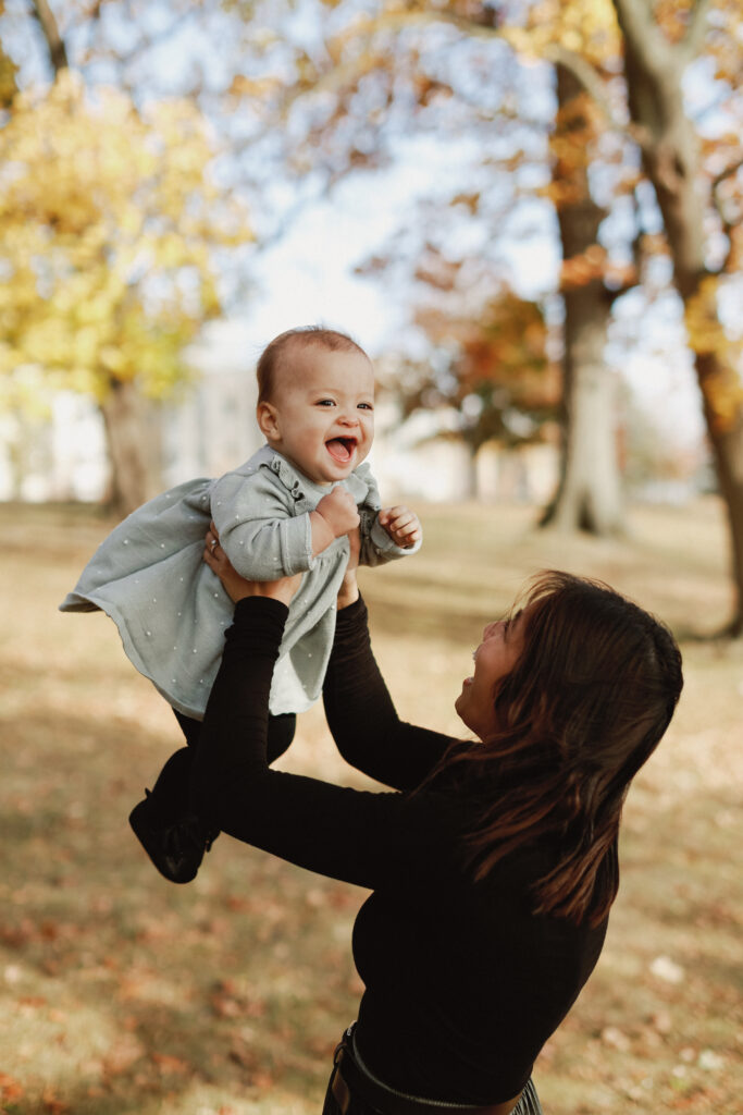 Mother holds baby in the air. Kingston Ontario Wedding Photography