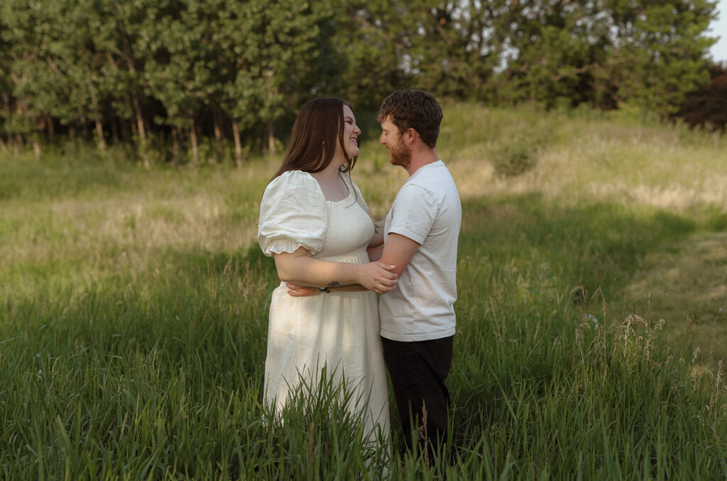 couple holds each other in field
