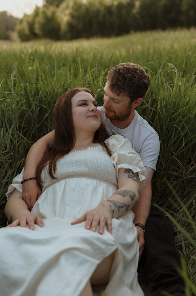 Couple lays down in field