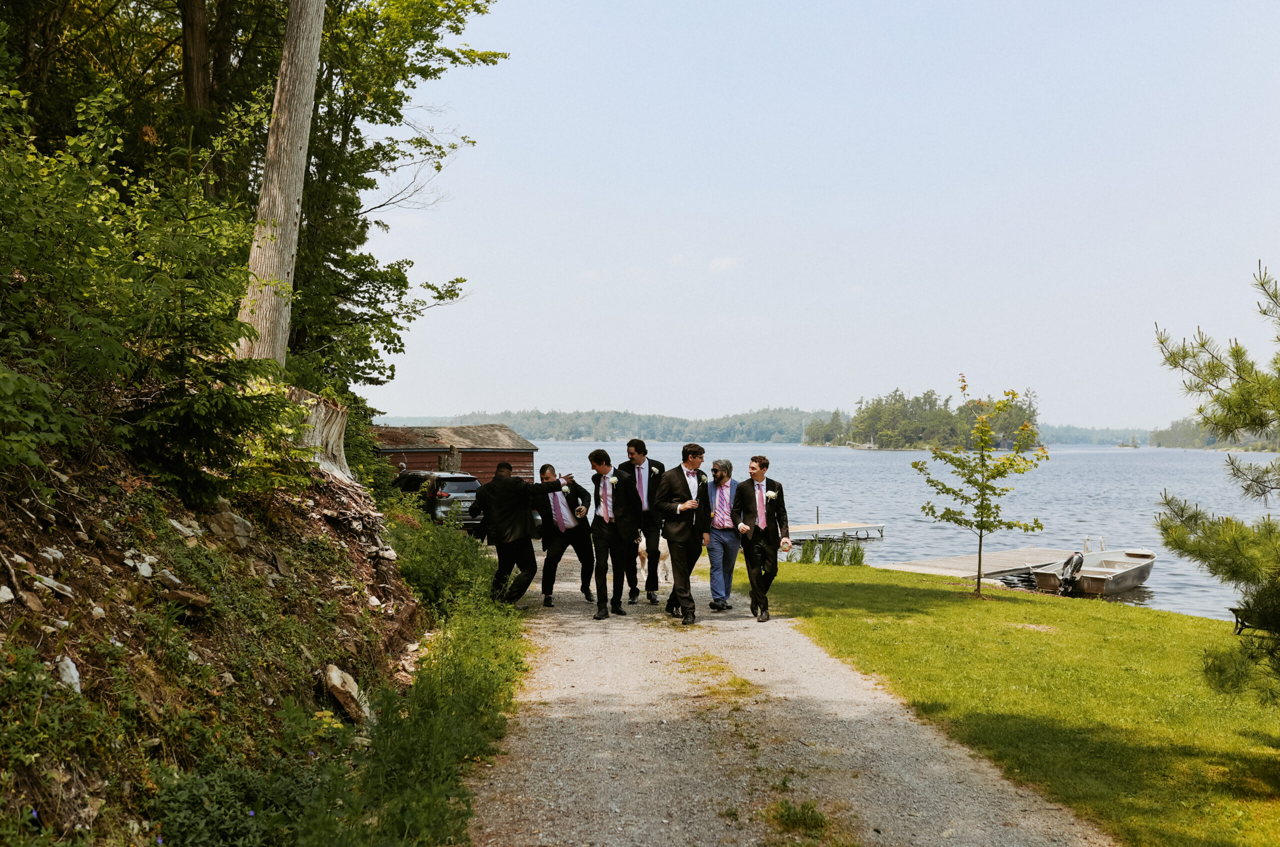 Groomsmen walk together towards vehicles to go to wedding