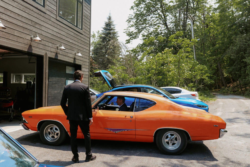 Groomsmen get ready to leave, pose in old cars