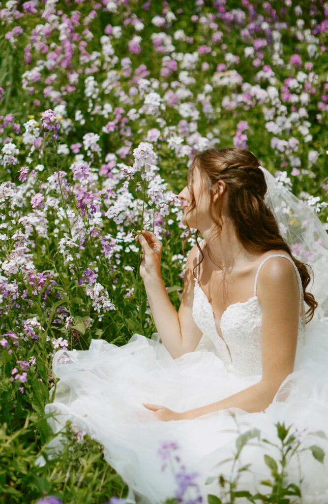 bride sits in wildflowers 