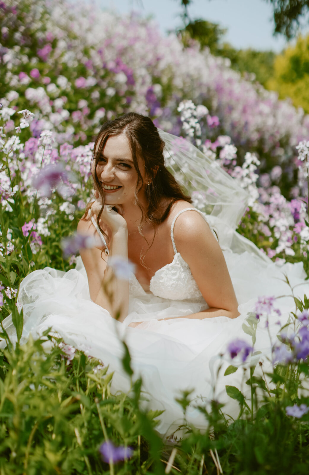 Bride seated in wildflowers