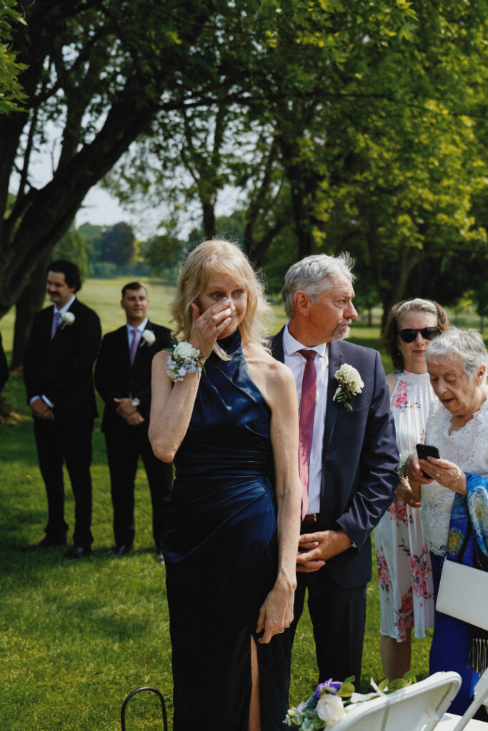 Mother of the groom wipes tears
