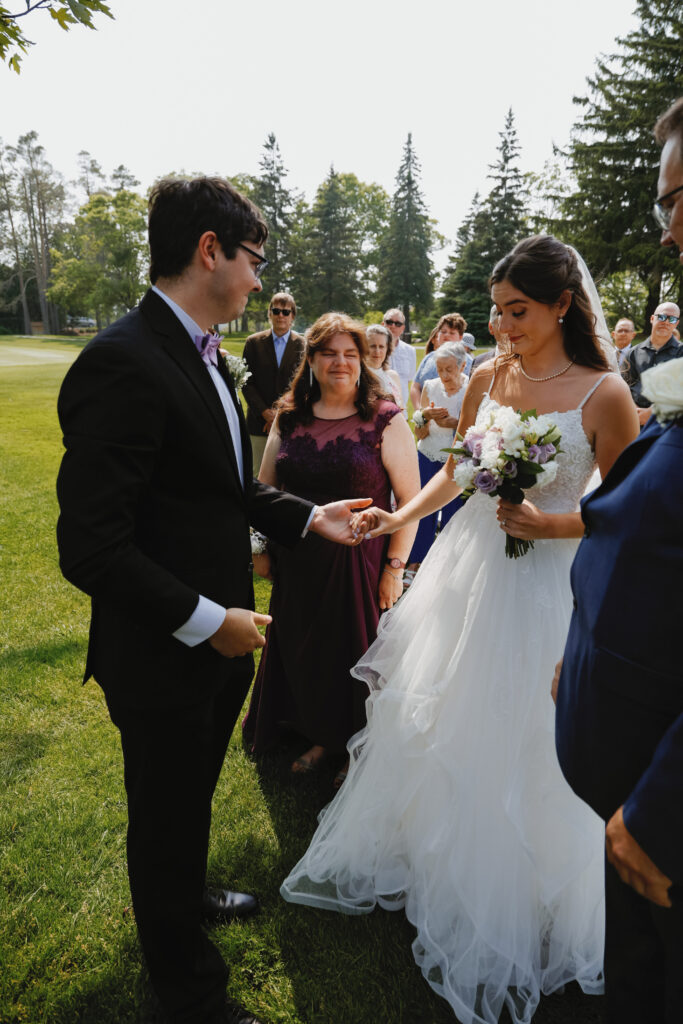 Bride holds hands with groom 