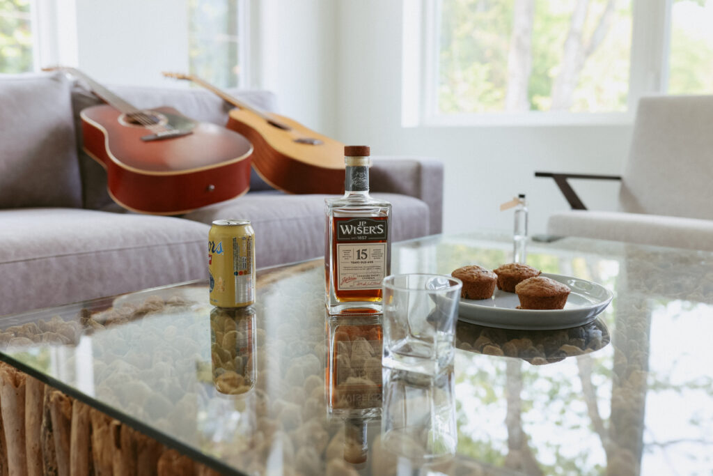Guitars on coach with wiser whisky on table