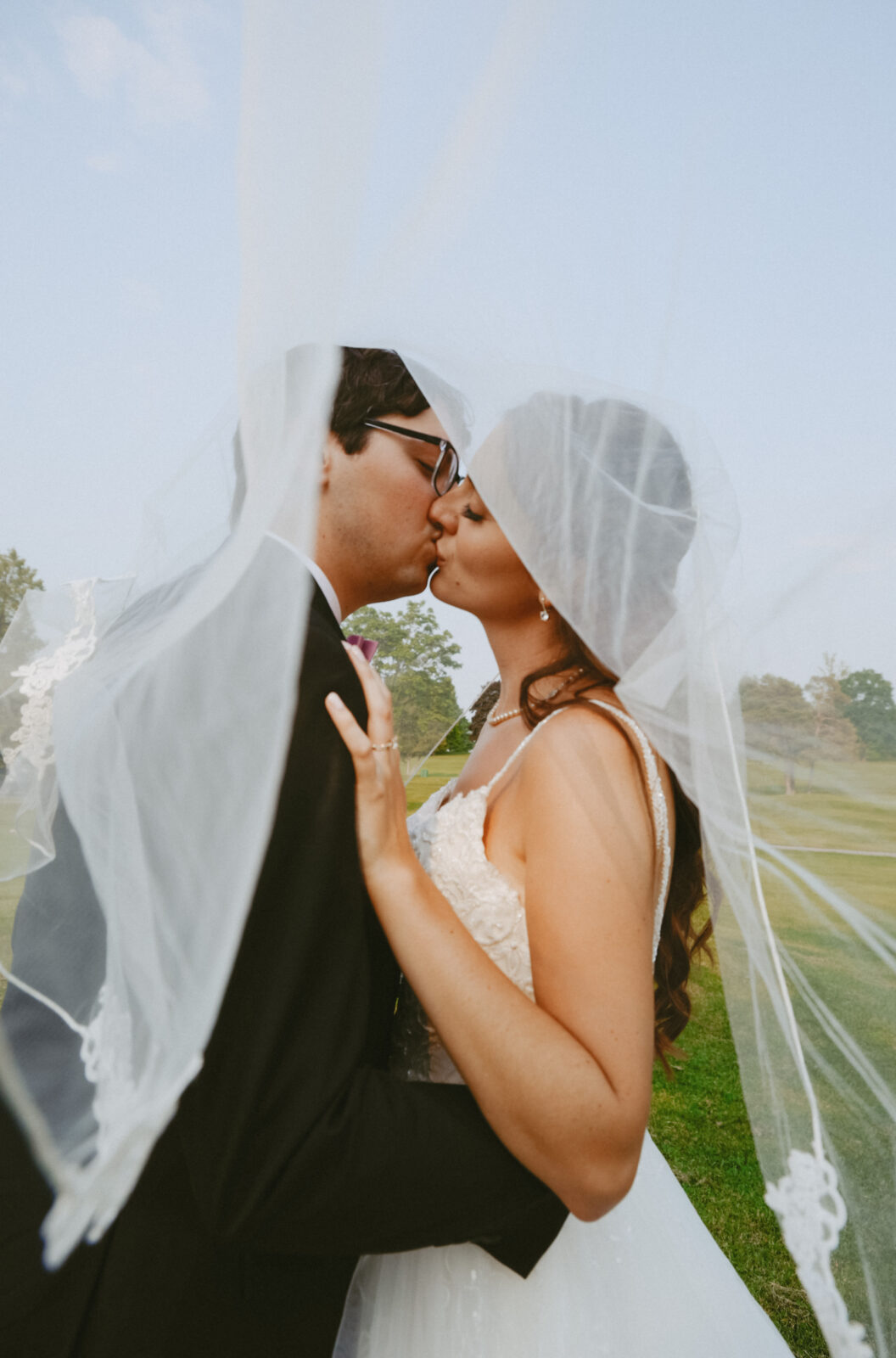 Bride and Groom kiss under veil