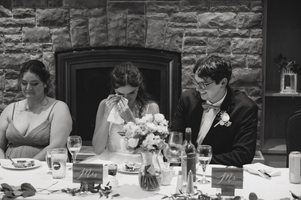 Bride wipes tear during wedding speeches 