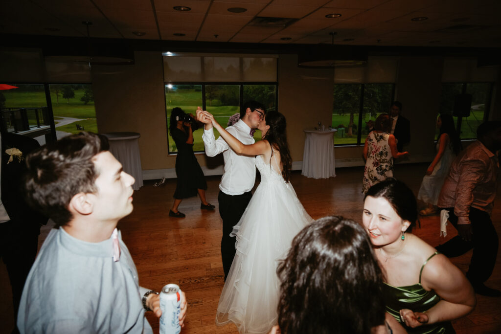 Bride and Groom kiss while dancing