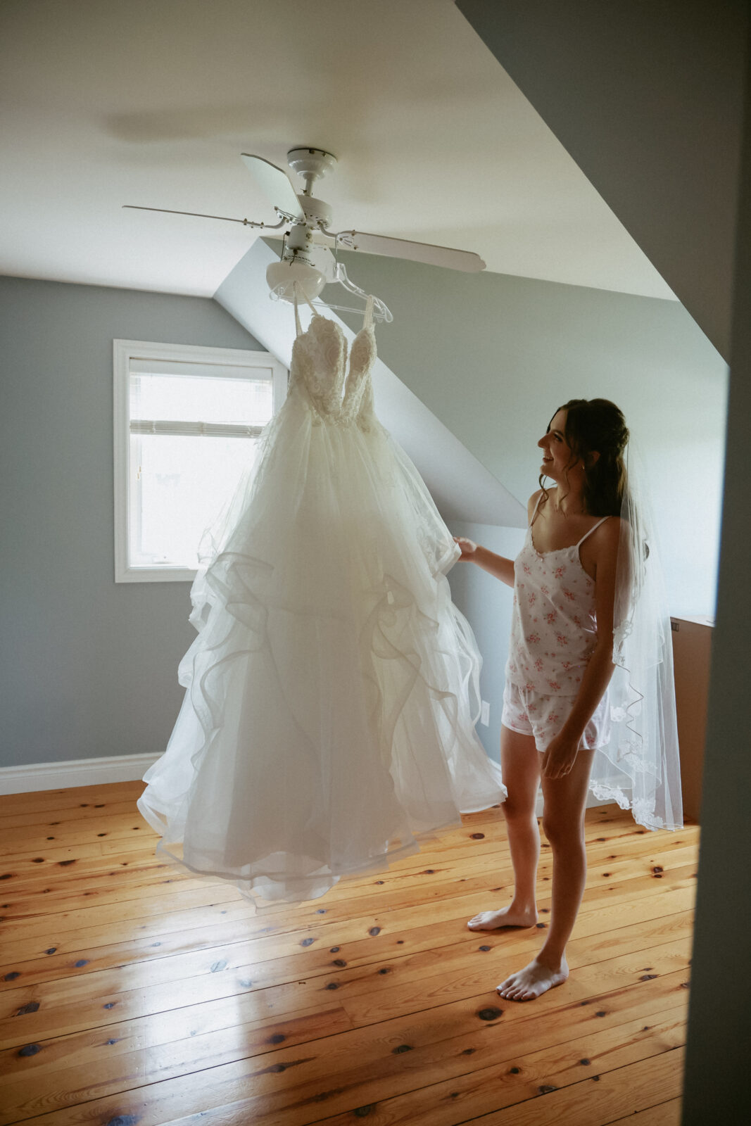 Bride stand next to hung dress