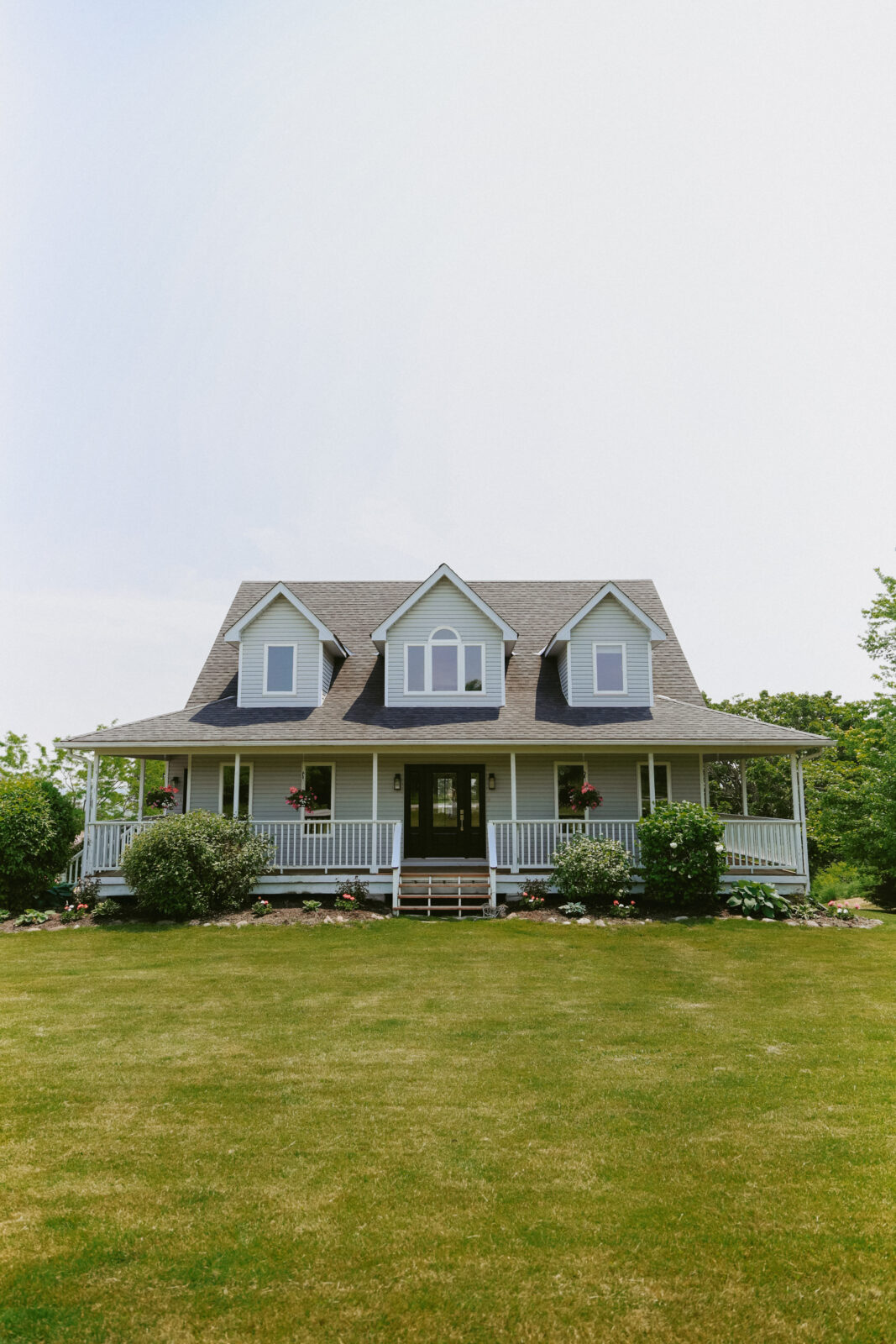 Blue house with wrap around porch