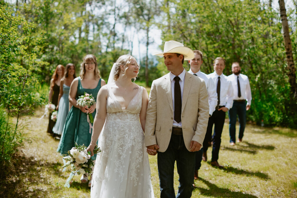 Bride and groom in forefront with bridal party behind them. 