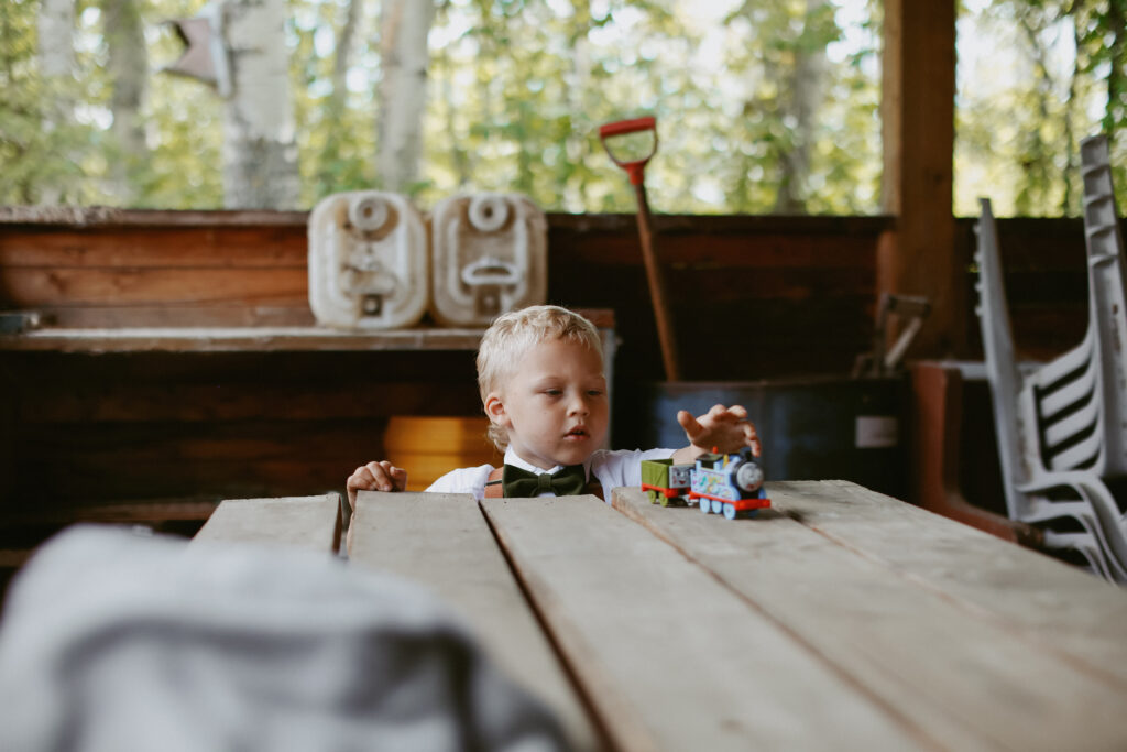 little boy plays with train 