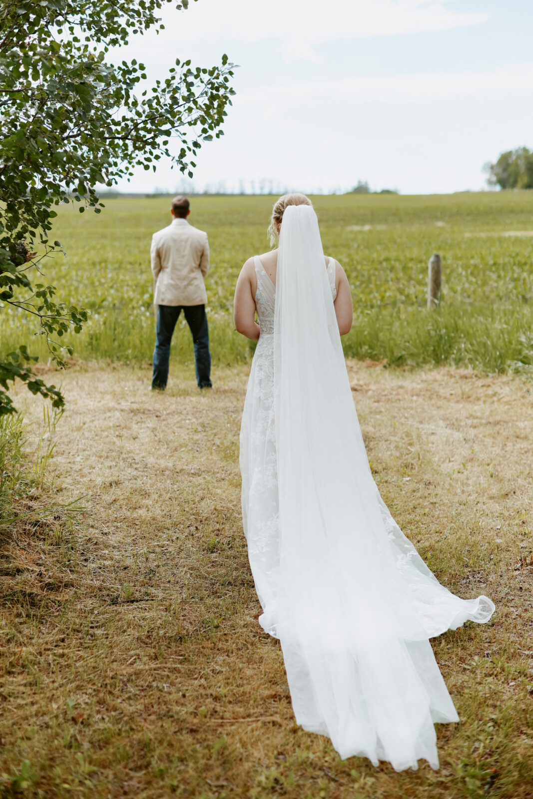 First look. Bride approaches groom